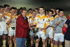 Aiden O'Rourke chairman of West Cork board na Nóg presents Bandon U16 captain barry Collins with the cup after they defeated Bantry to win the West Cork U16A football final under lights at Sam Maguires Dunmanway on Wednesday. Picture Denis Boyle